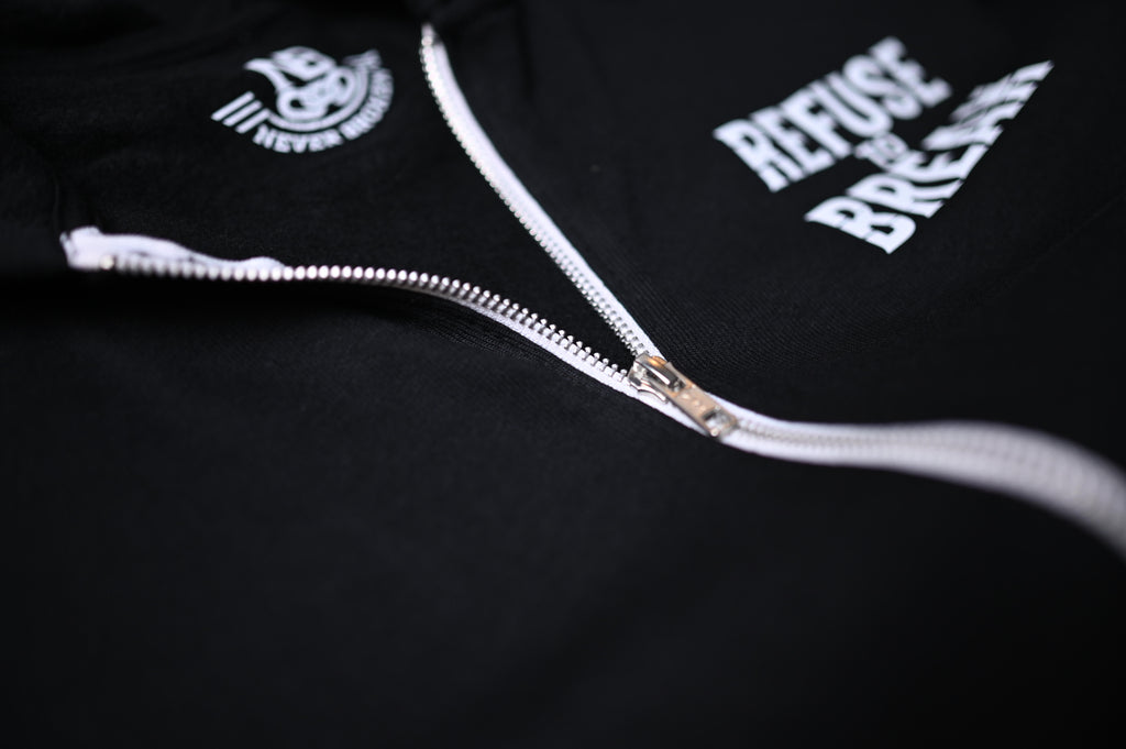 Black hoodie with white zipper and text on a dark background