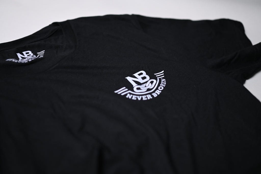 Black t-shirt with 'Never Broken' logo on a white background
