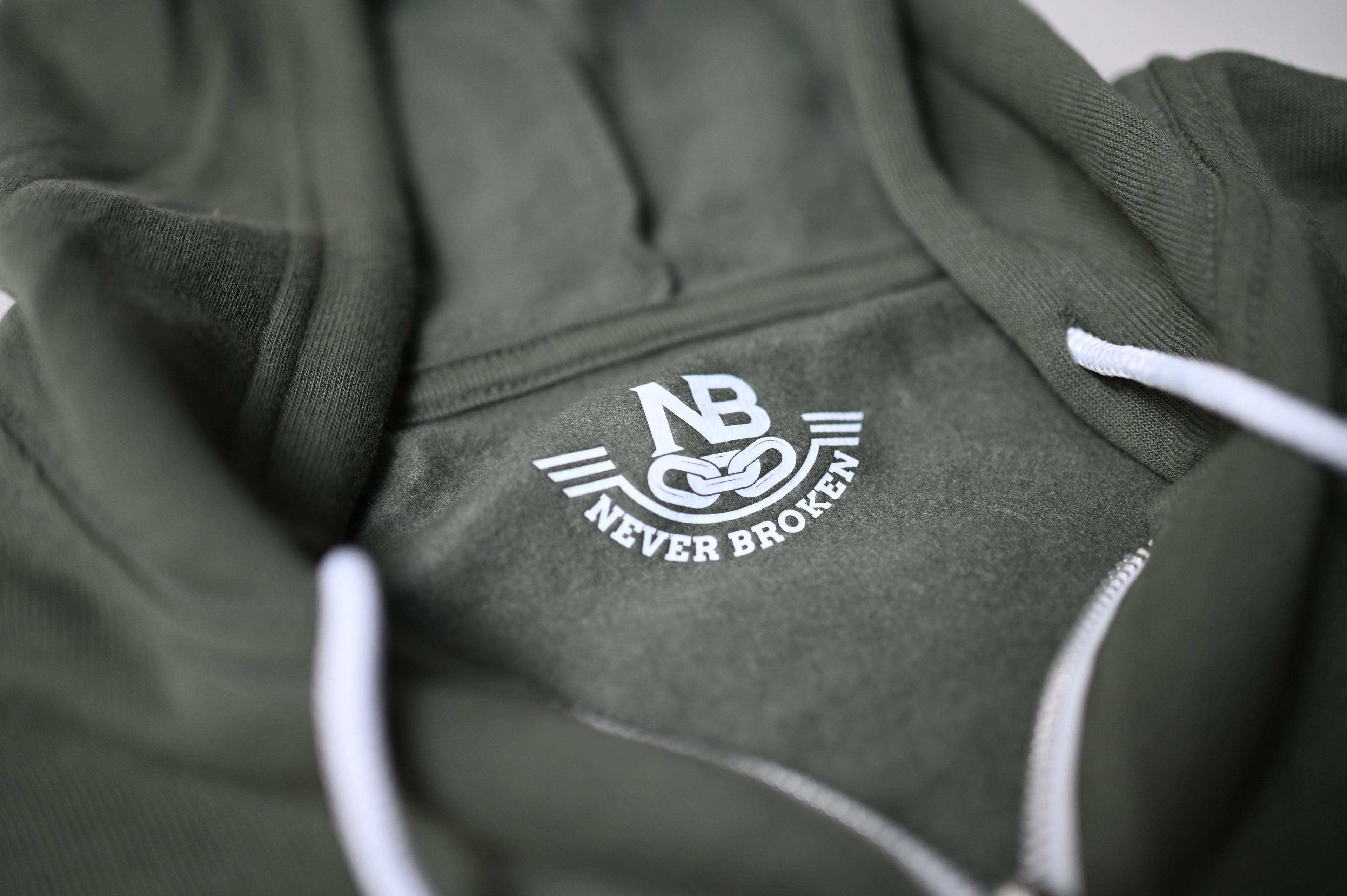 Green hoodie with 'Never Broken' logo on a plain background