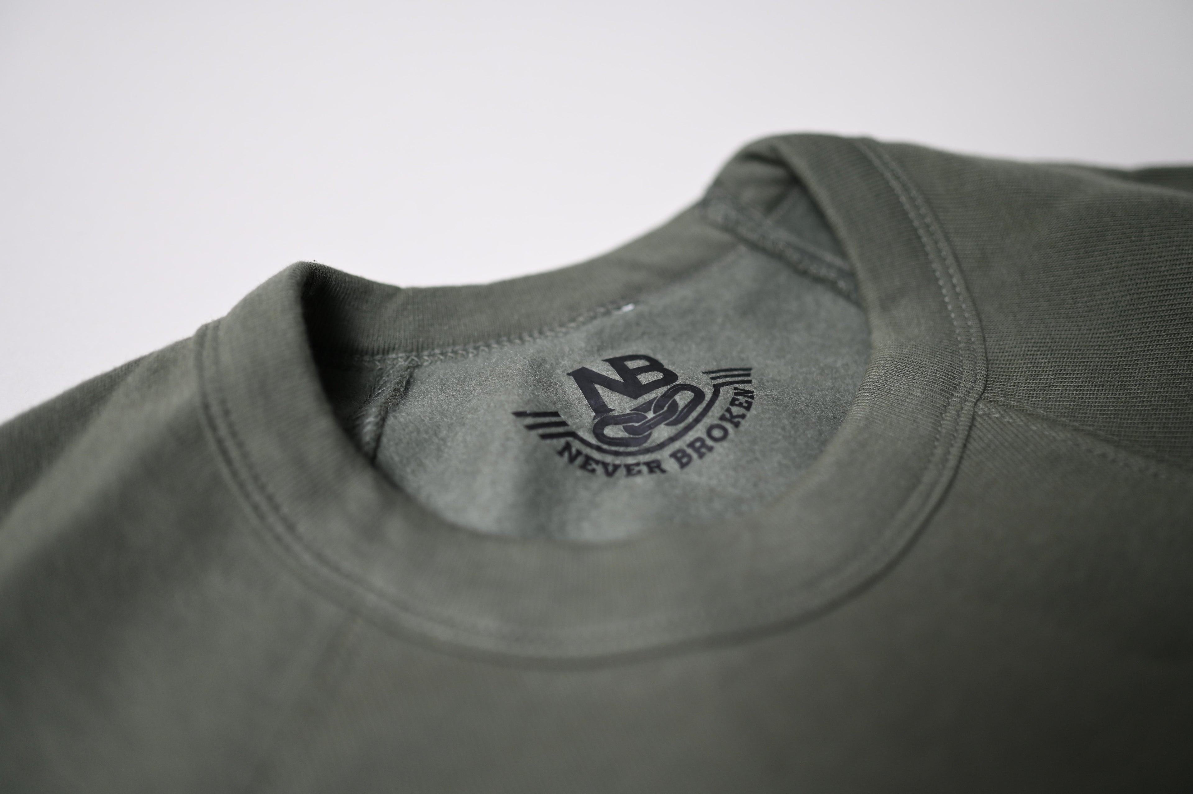 Gray sweatshirt with 'Never Broken' logo on a white background