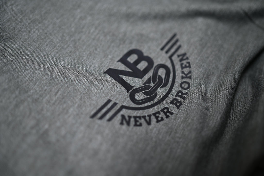 Gray fabric with 'Never Broken' logo in black
