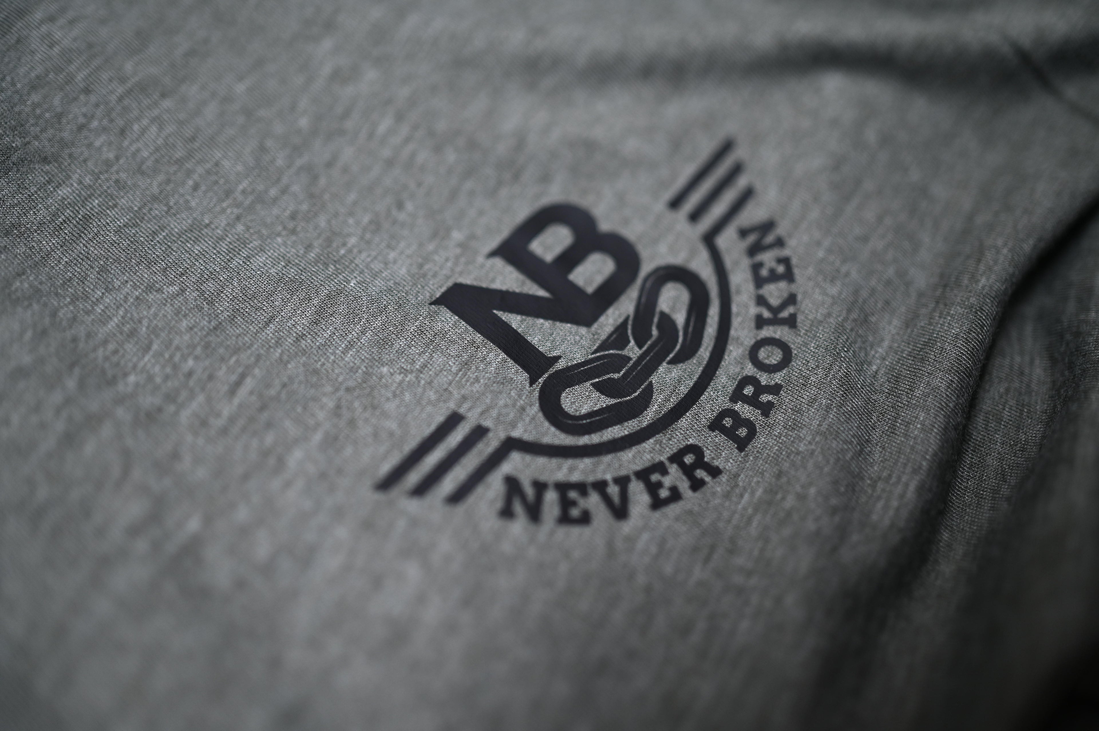 Gray fabric with 'Never Broken' logo in black