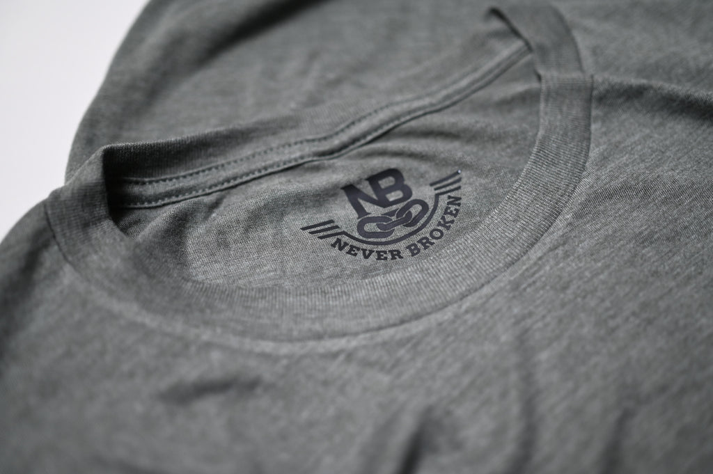 Gray t-shirt with 'Never Broken' logo on a white background