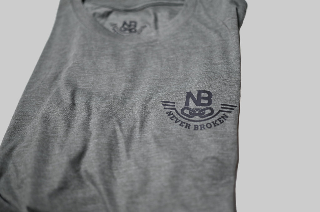 Gray tank top with 'Never Broken' logo on a white background