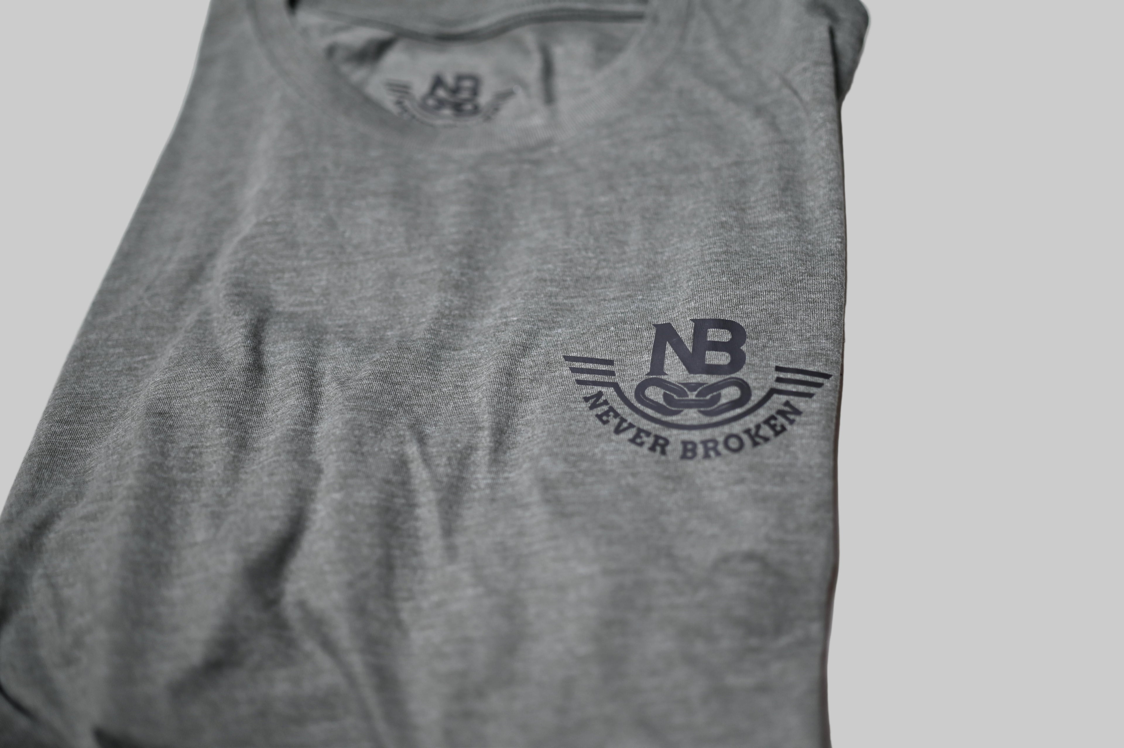 Gray tank top with 'Never Broken' logo on a white background