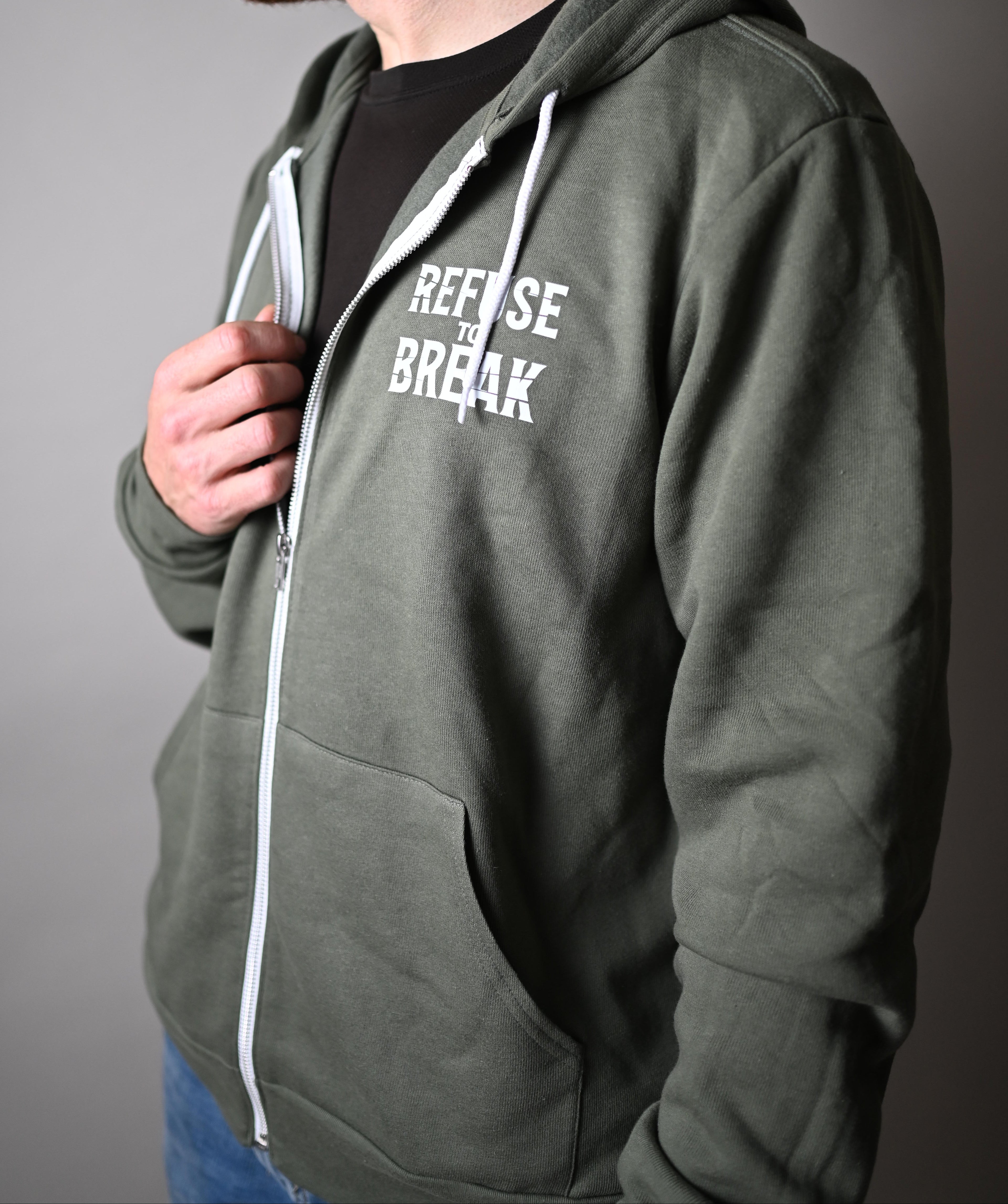 Person wearing a green hoodie with text on a gray background