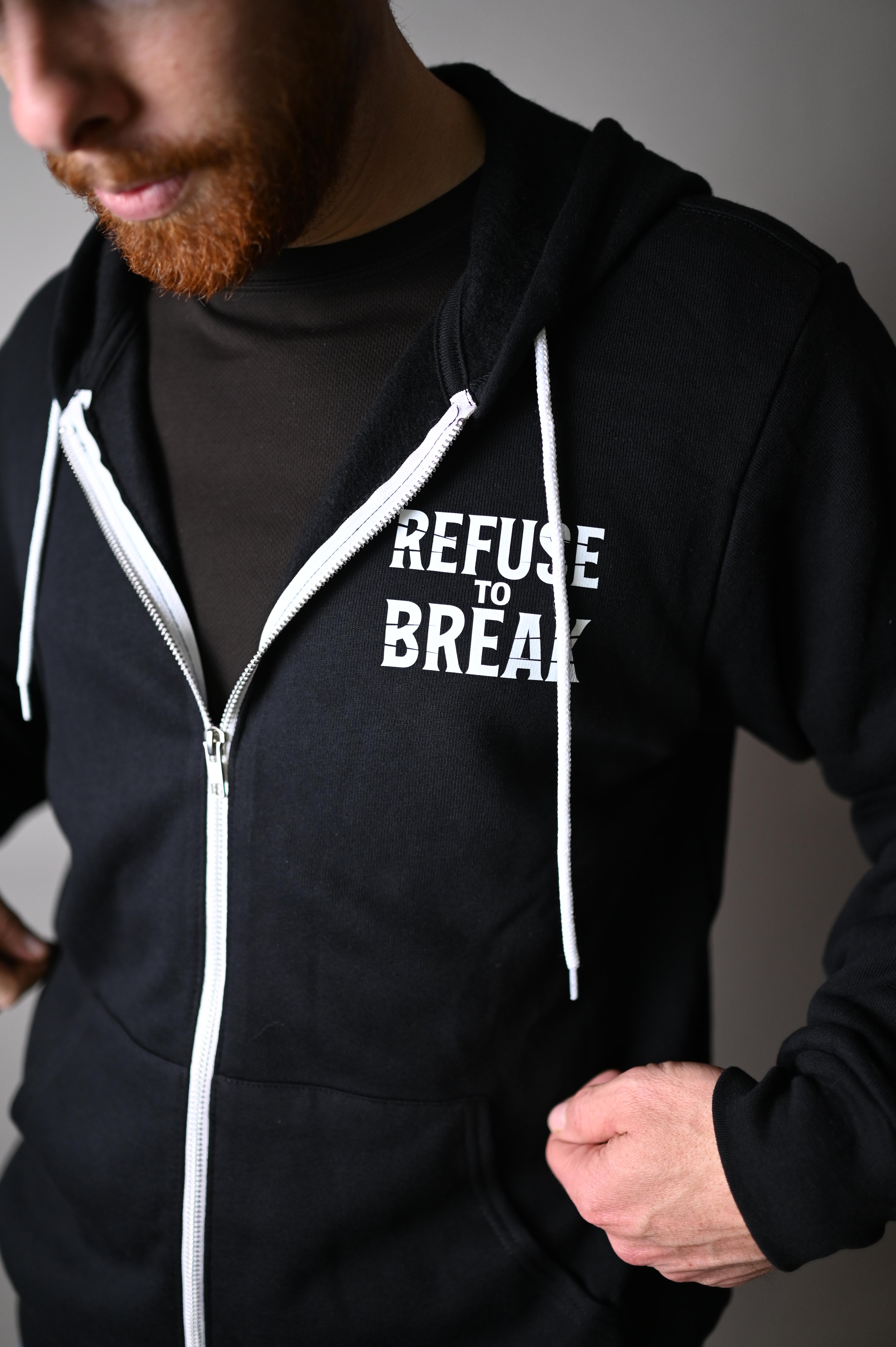 Person wearing a black hoodie with 'Refuse to Break' text, zipped up.