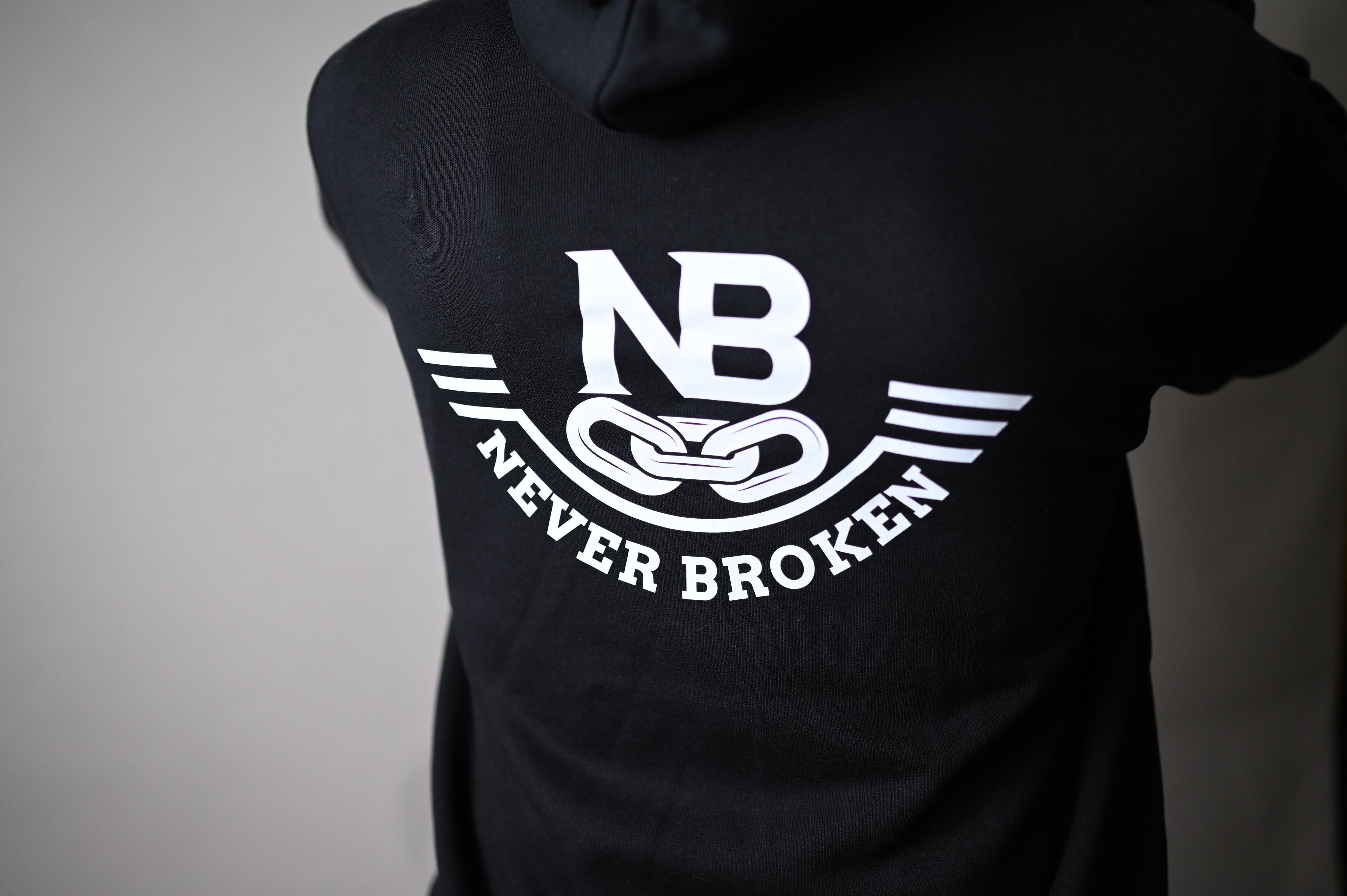 Black t-shirt with 'Never Broken' logo on a plain background