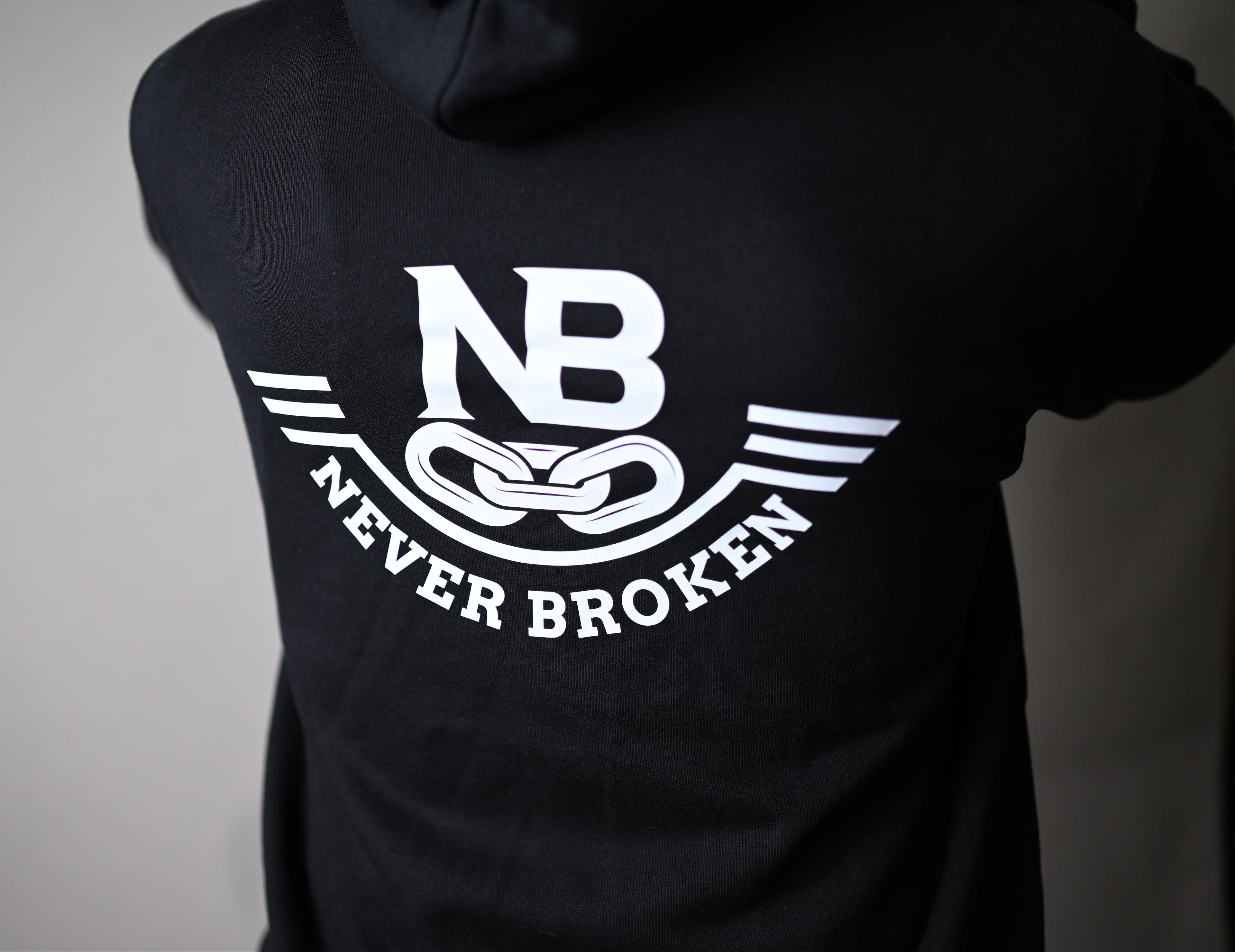 Black t-shirt with 'Never Broken' logo on a plain background